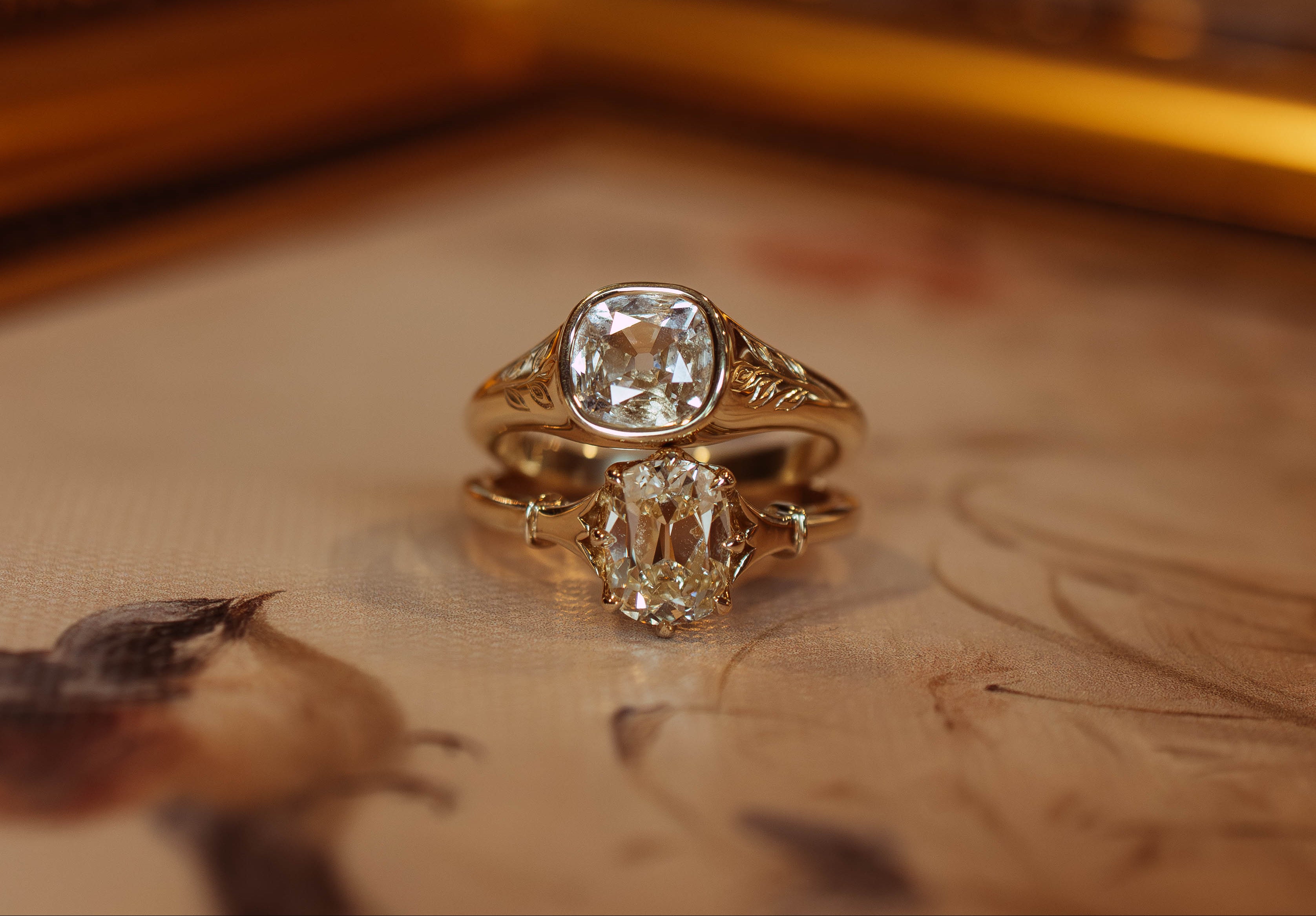 Gold ring with a large diamond on a textured surface