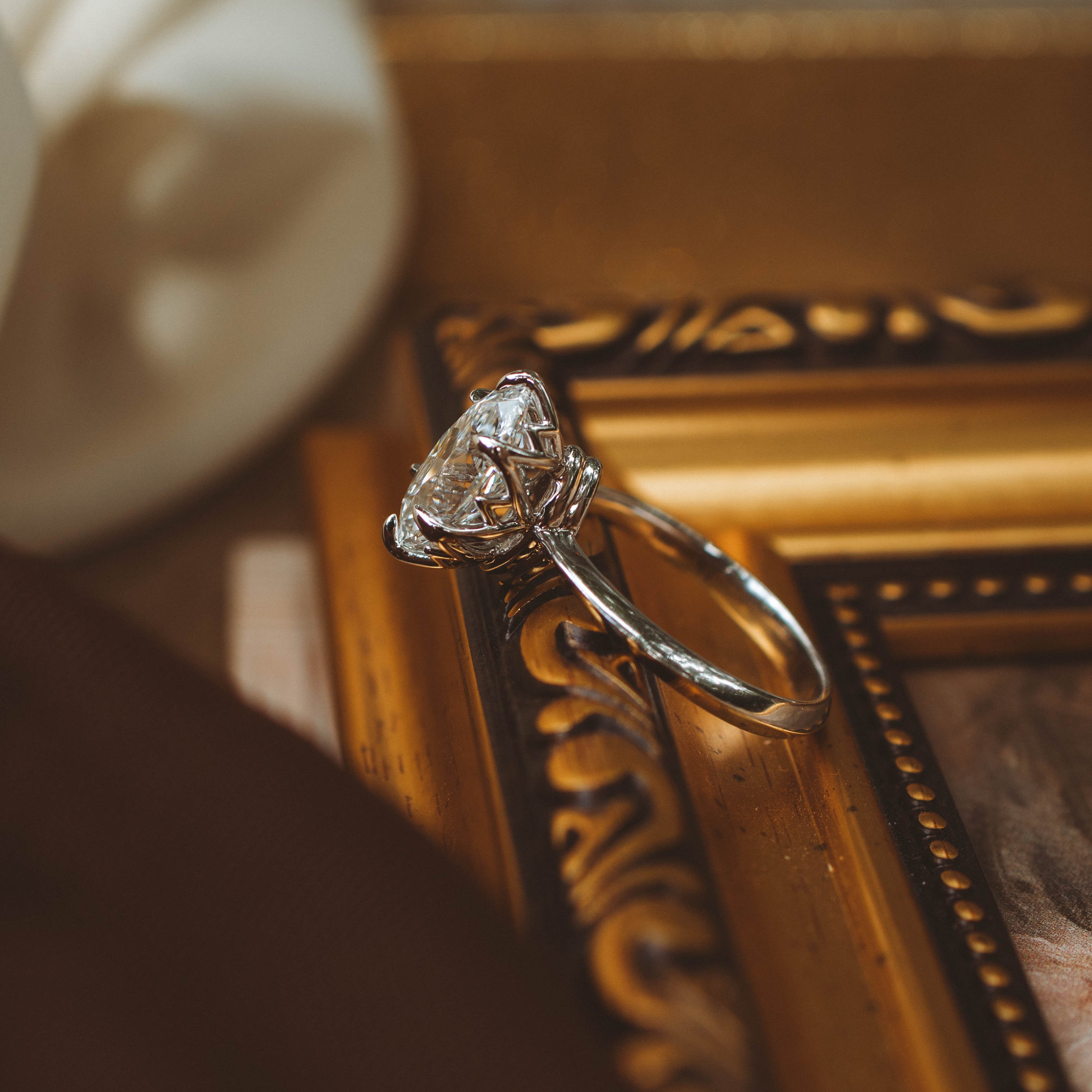 moval diamond white gold solitaire profile basket view on gold frame