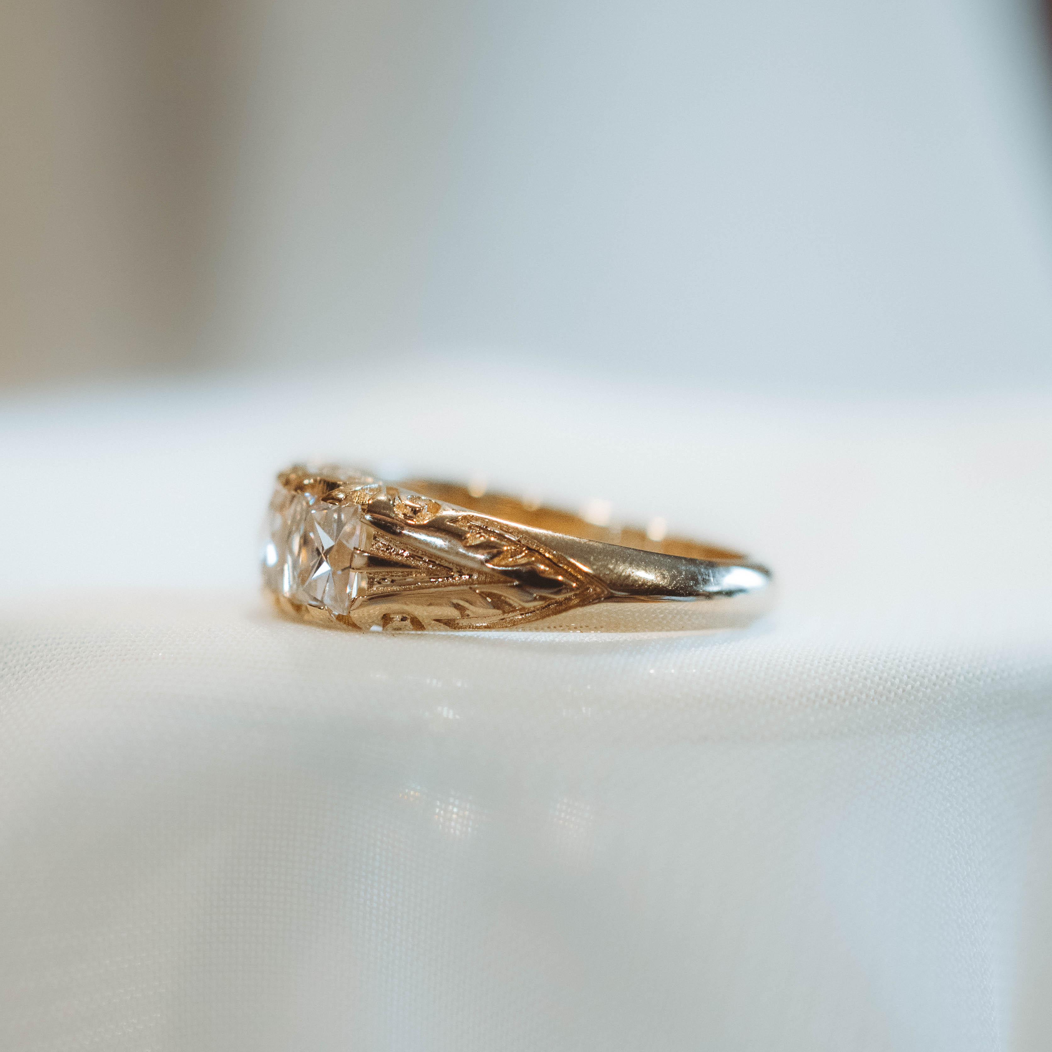 Gold diamond band ring with diamond on a white background
