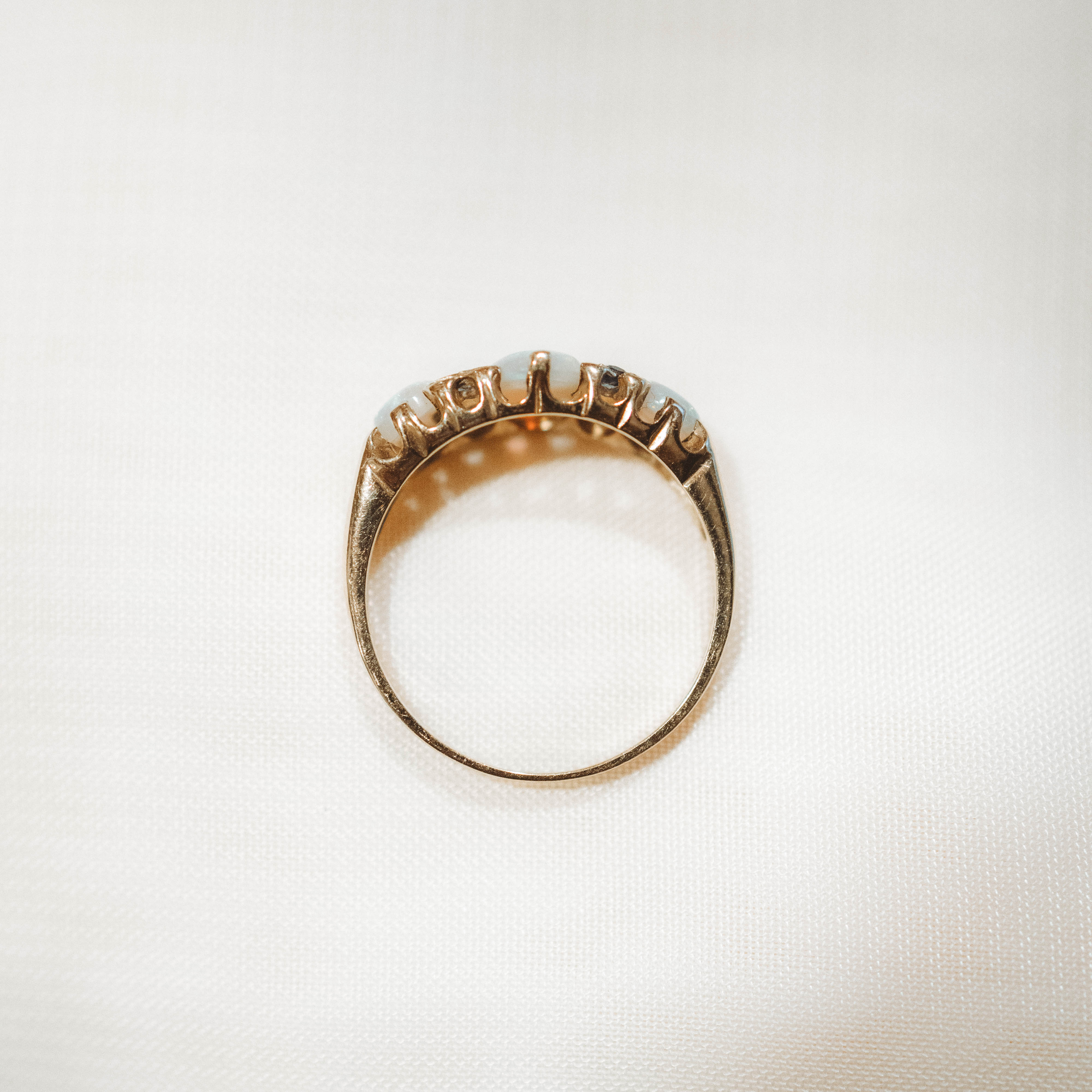 vintage Gold band ring with opals on a white background