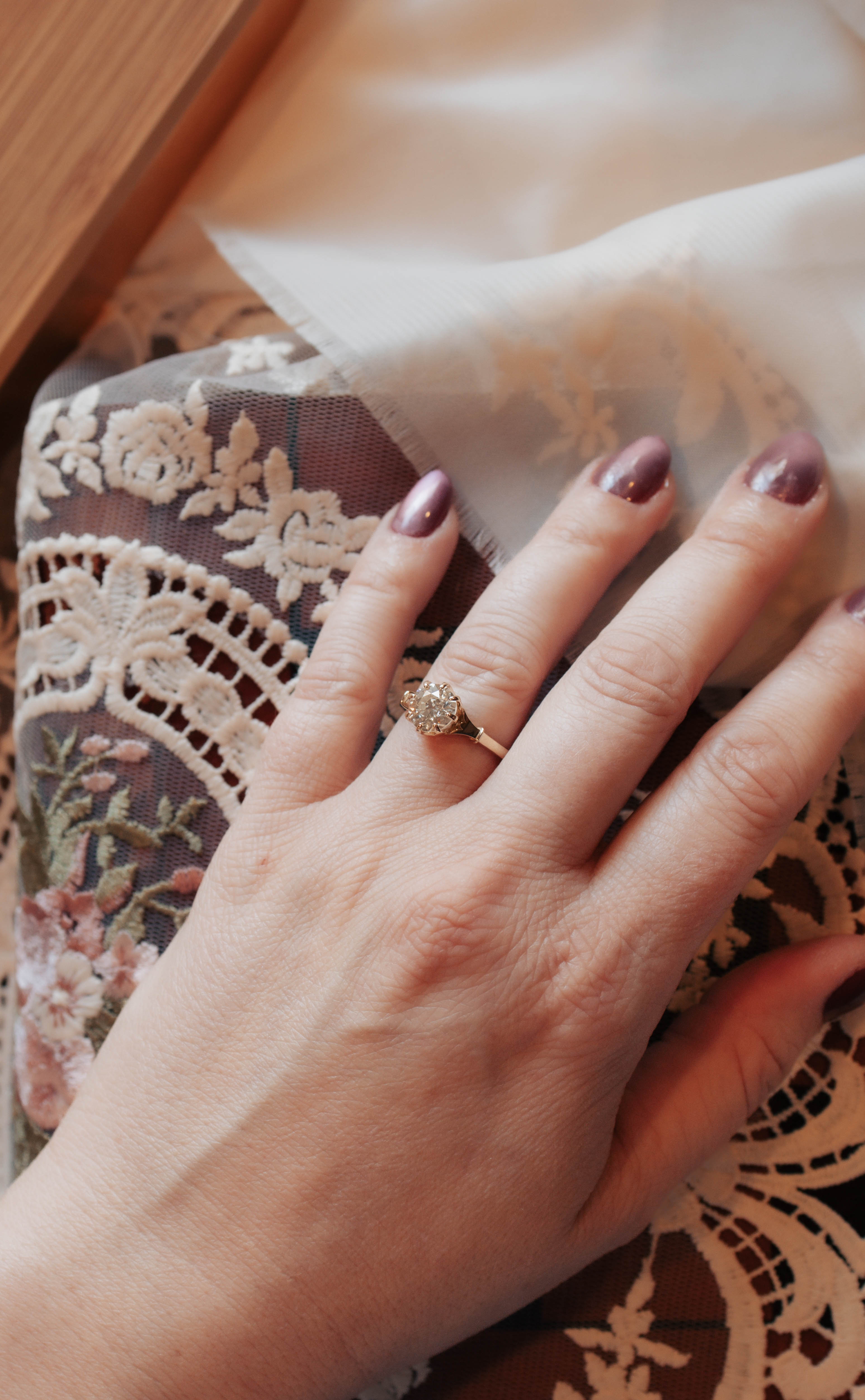 old european gold engagement in decorative basket on hand
