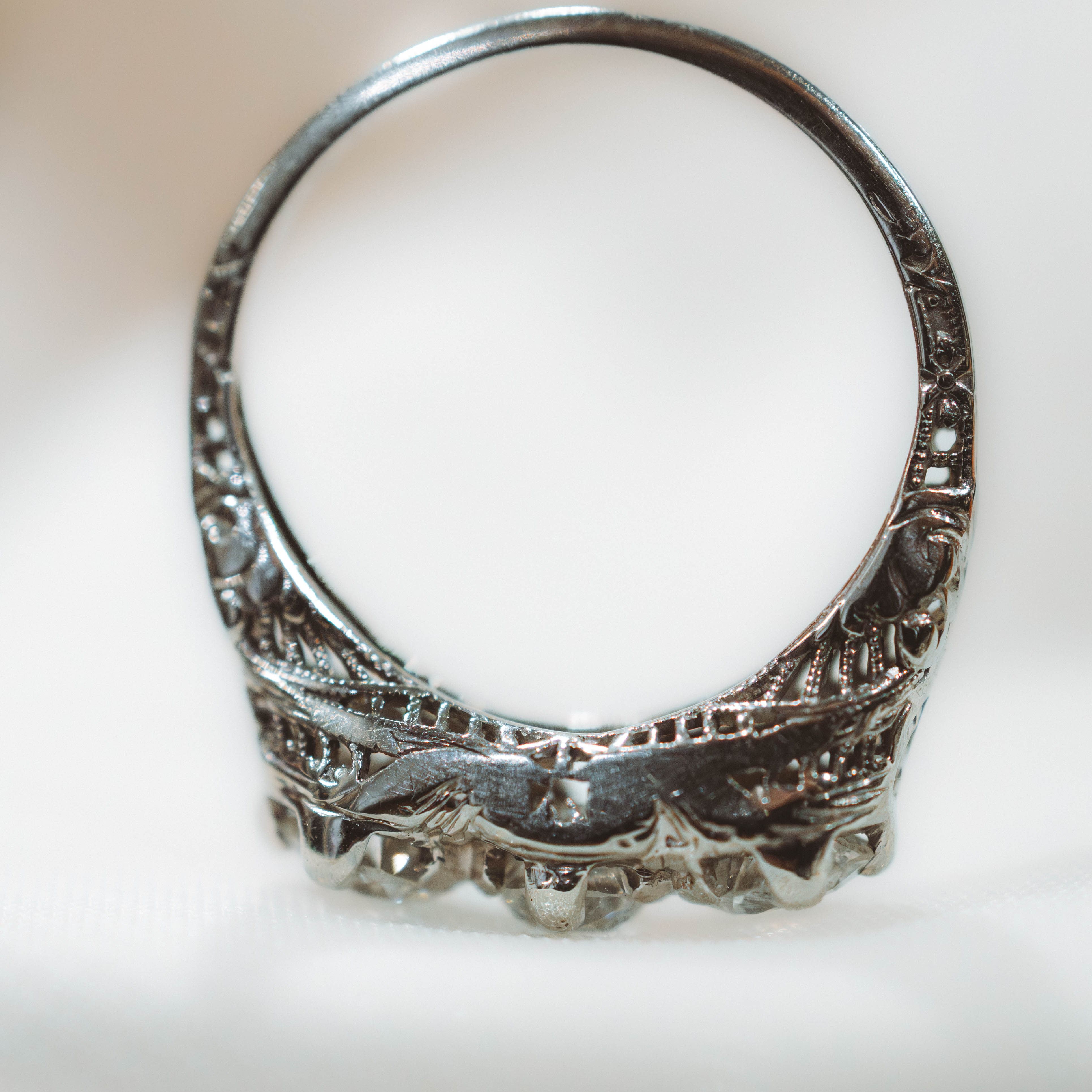 white gold art deco ring with intricate designs on a white background