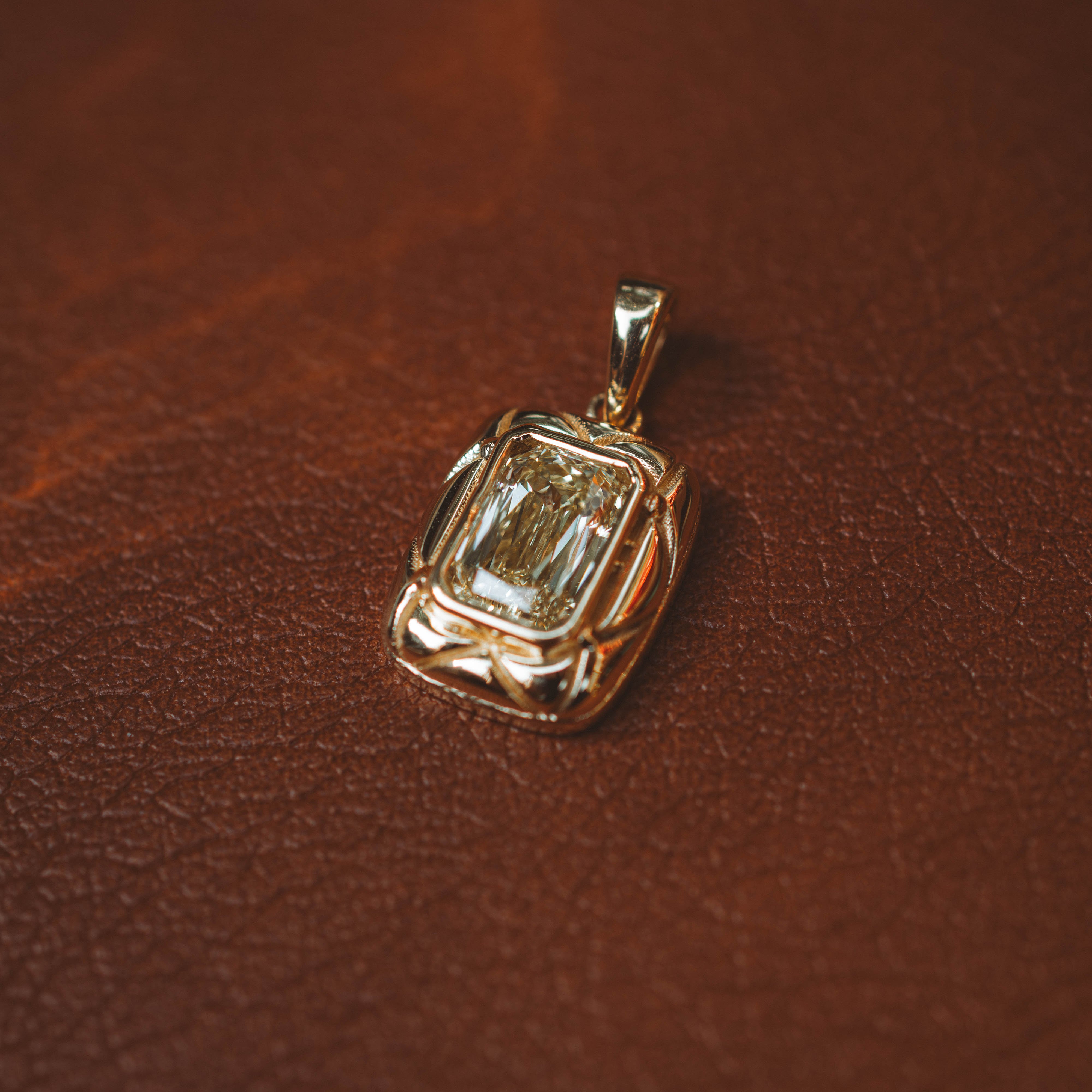 yellow gold and yellow diamond pendant on leather book vintage