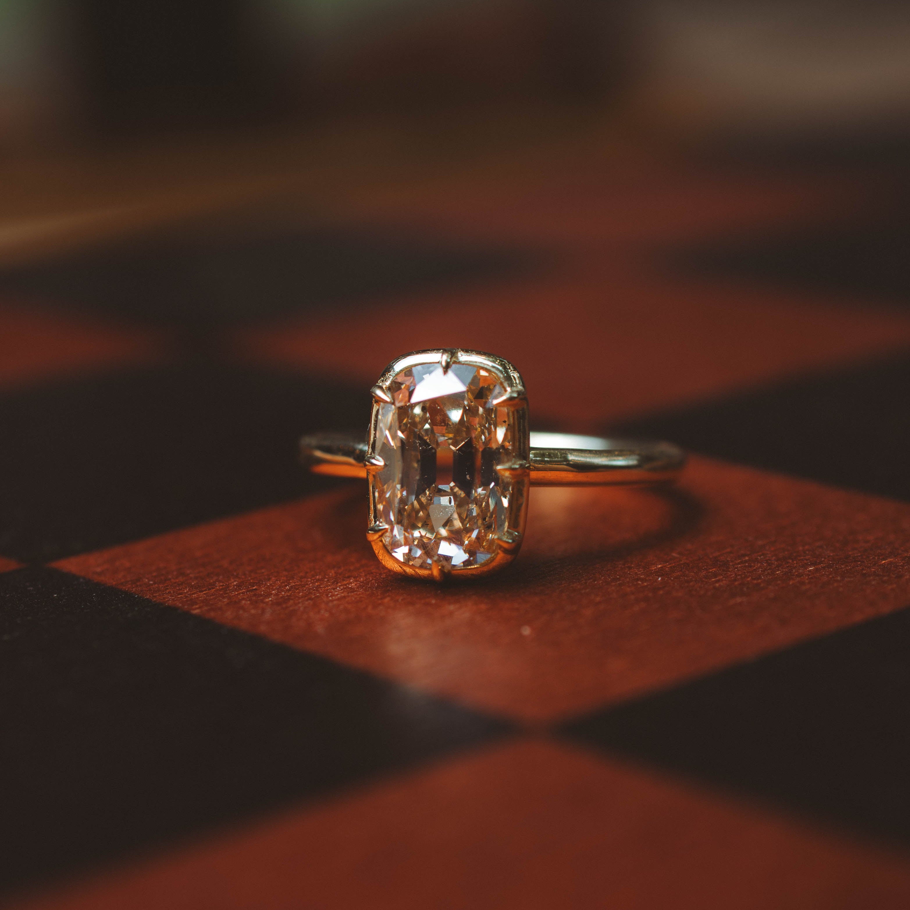 Diamond ring on a checkered surface with a blurred background