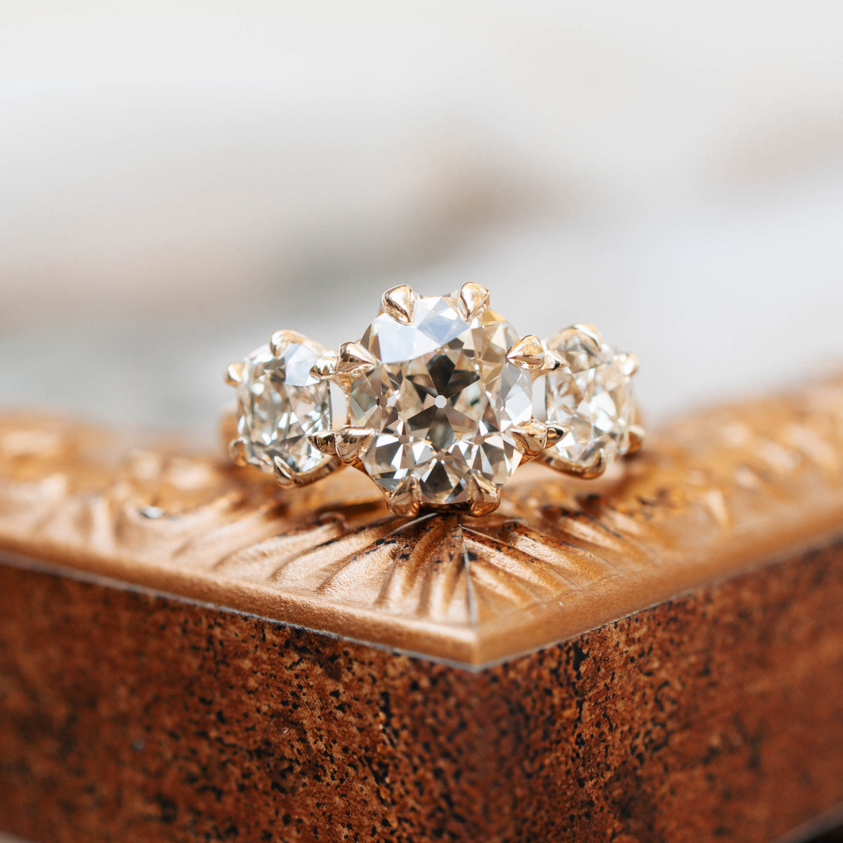 three stone diamond ring sitting on photo frame