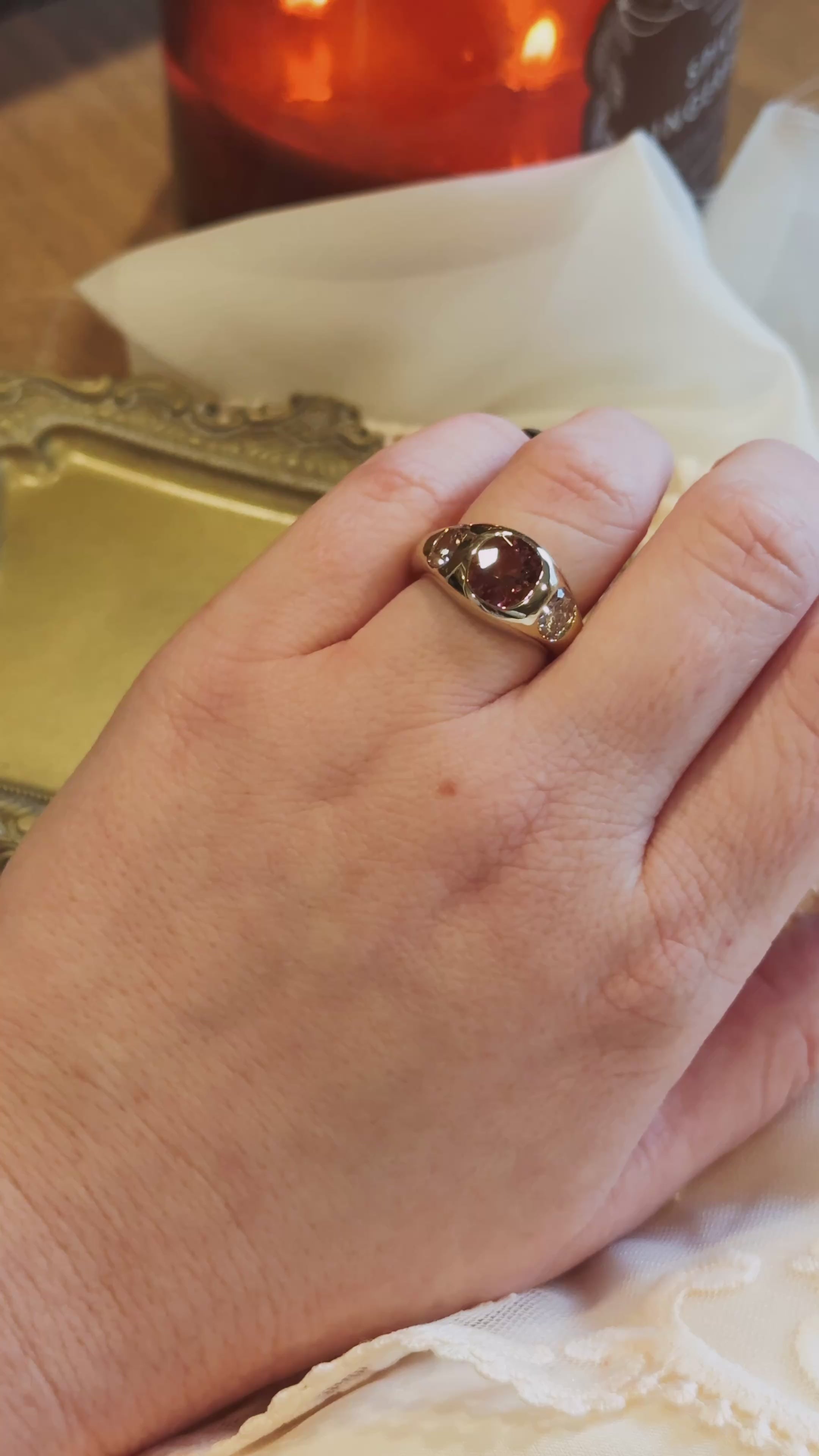 video of gold flush set ring on hand with tourmaline and natural old mine diamonds