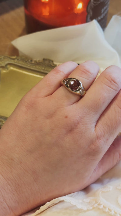 video of gold flush set ring on hand with tourmaline and natural old mine diamonds