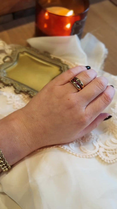 video of hand with chubnky gold and ruby band