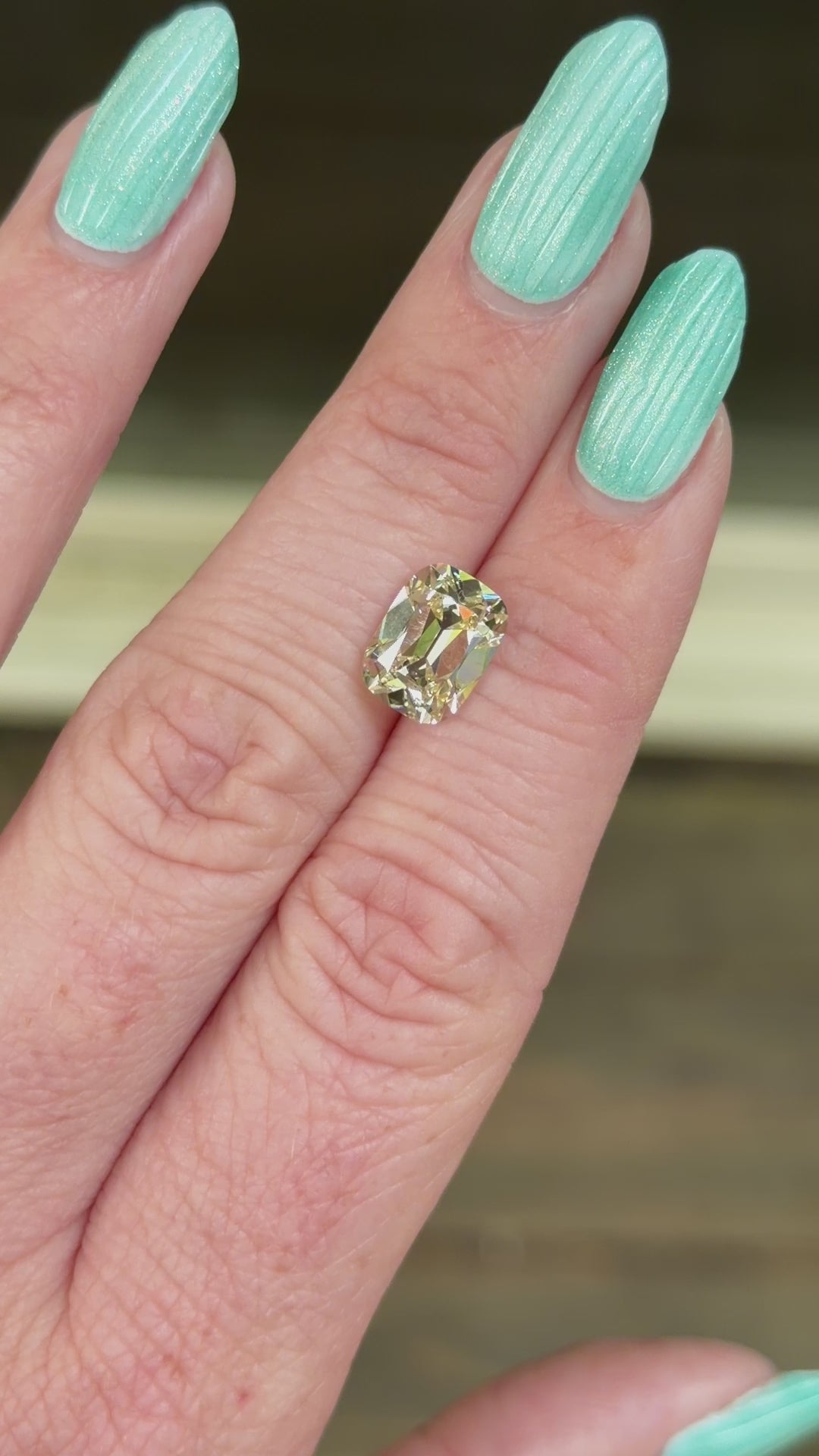 warm old mine lab diamond shown on hand in indirect sunlight