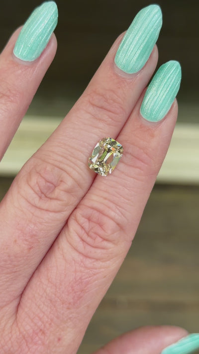 warm old mine lab diamond shown on hand in indirect sunlight