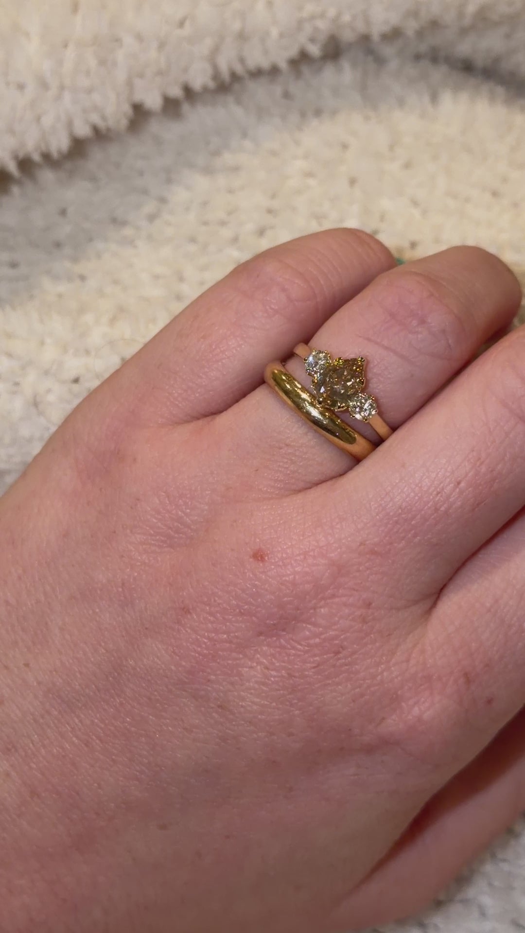 video of three stone diamond ring being shown with wedding band