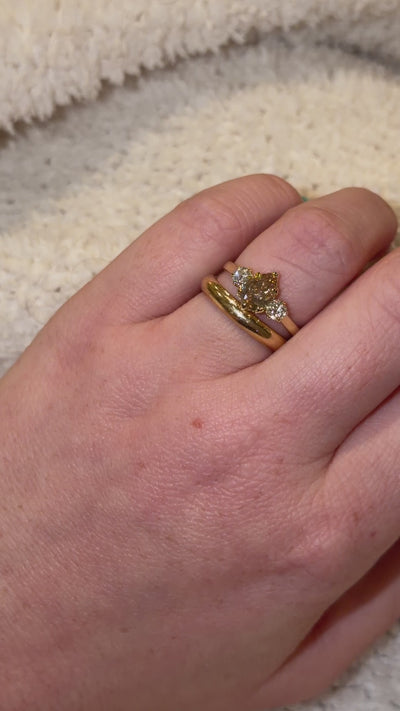 video of three stone diamond ring being shown with wedding band