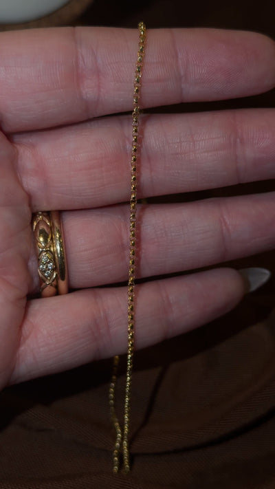 Video of the 14k gold petite rolo chain in motion