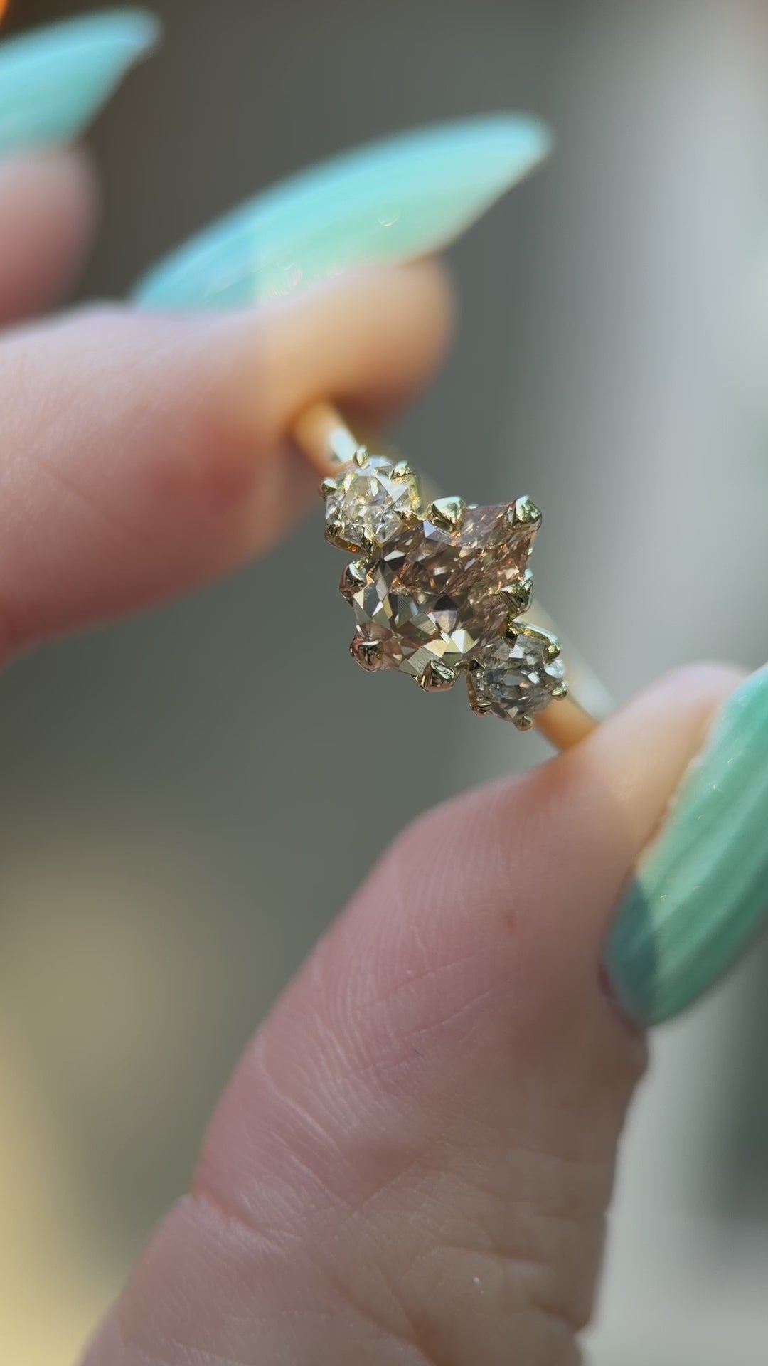yellow gold 3 stone ring shown in sunlight